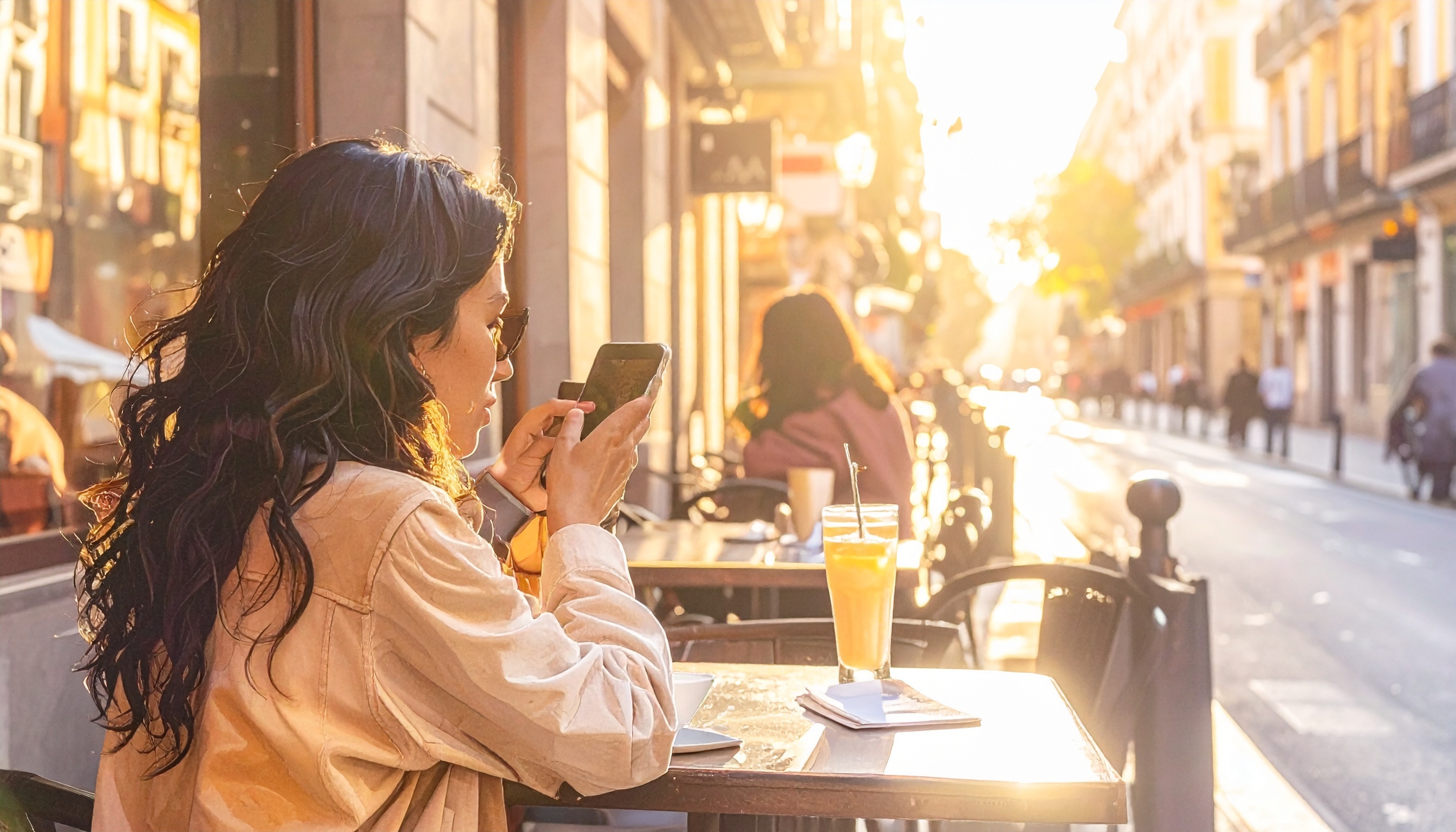 Firefly_Influencer photographing with her phone a Madrid street café — warm tones, natural li 304790