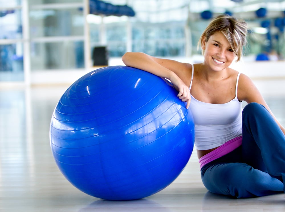 Woman at the gym with a pilates ball